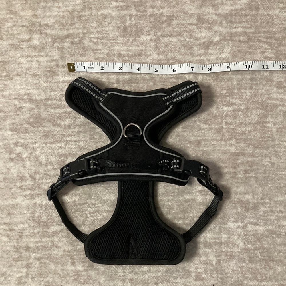 Black dog harness with reflective detail. Front and back clip.